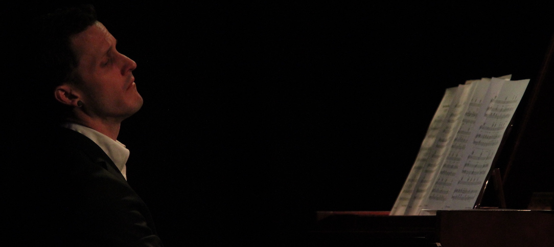 Gentleman in suit playing piano with passion